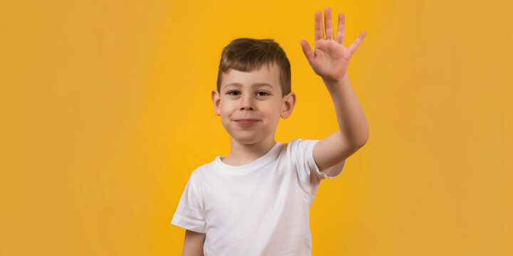 A deaf austic boy looking at the camera and using sign language to say thank you
