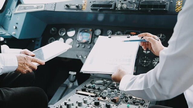 Young pilot man in uniform talking with business man about aviation businessn,startup,business team,people,Young caucasian pilot and businessman talking about Aviation business at the airport terminal