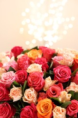 Beautiful bouquet of colorful roses on beige background