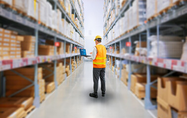 Obraz premium Asian worker or engineer in warehouse with cardboard boxes