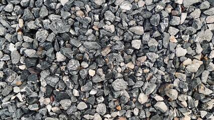 Crushed grey stone on the ground texture background, Crushed rock close up, Crushed stone road building material gravel texture, Garden gravel background stone landscaping
