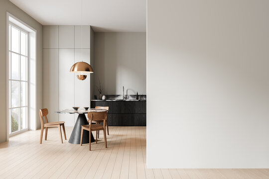 Modern kitchen with dining table and chairs, in a minimalistic style, on a hardwood floor. Light and spacious home interior concept.  3D Rendering
