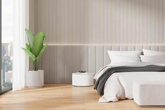 Modern bedroom with a gray headboard, potted plant, minimalist side table, floor to ceiling window. Light gray wall panels. Concept of interior design.  3D Rendering