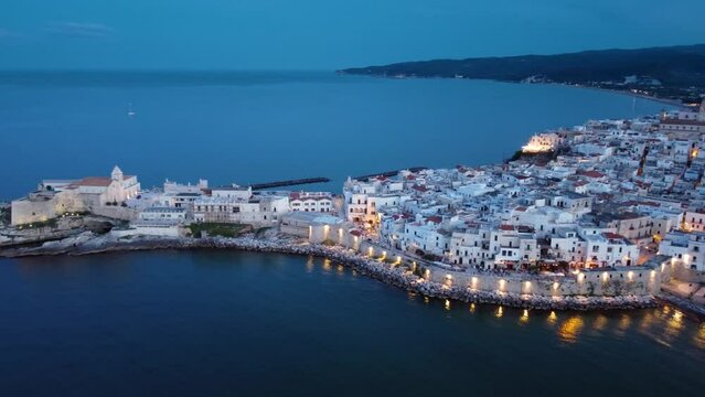Aerial 4K dusk view of the beautiful seaside town of Vieste, a coastal town in Gargano National Park, in southeast Italy