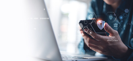 Cyber security, data protection concept. User using mobile phone and laptop computer with privacy security and data encryption system, secure internet access. Cybersecurity software technology