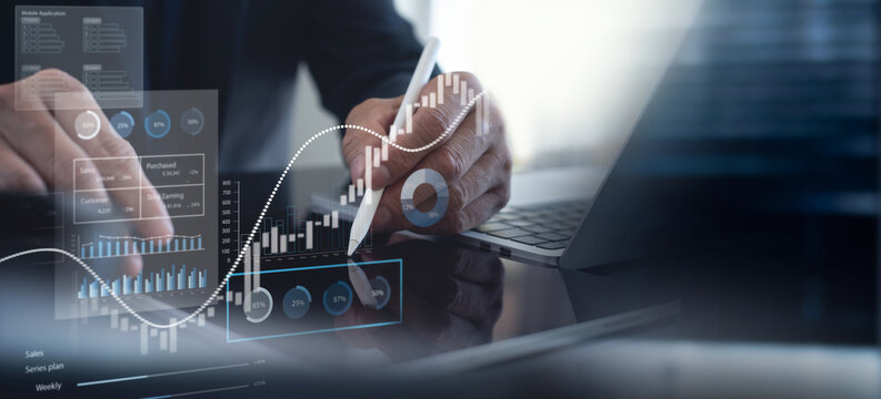 Businessman using tablet analyzing sales data and financial report, business growth graph chart. digital marketing planning and strategy, financial report, business, finance and investment concept