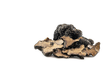 Cut and whole black truffles isolated on white