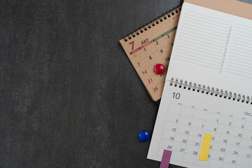 close up of calendar on the black table background, planning for business meeting or travel planning concept