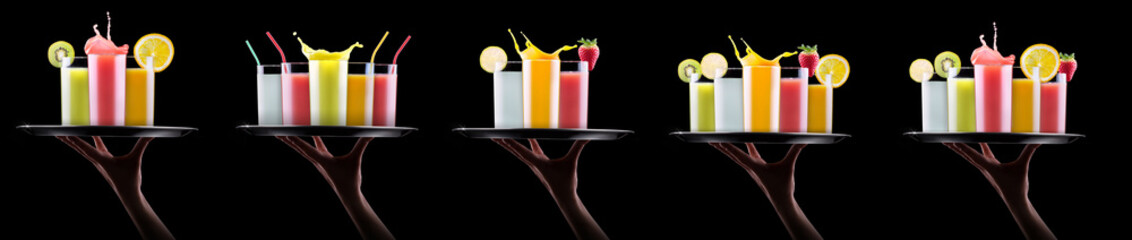 tasty summer fruit drinks in glass with splash on tray holding a woman hand