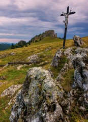 Fototapeta premium Mountain landscape with rocks, pastures for cattle and a small cross in the background. Slovak mountain nature Velka Fatra, Kralova Studna