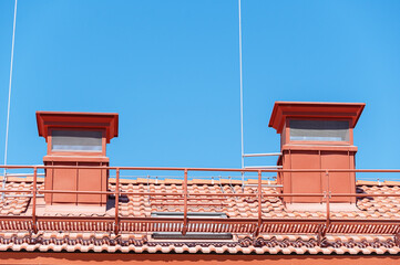 house with a roof from a red shingles with a pipe