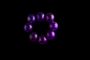 Purple spheres forming circle on black background