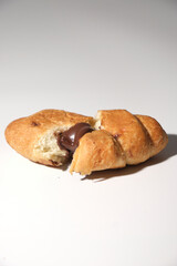 croissant cut in half on white background