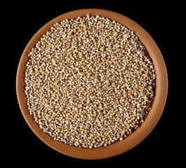 Amaranth pops in clay pot, popped grains isolated on black background, top view