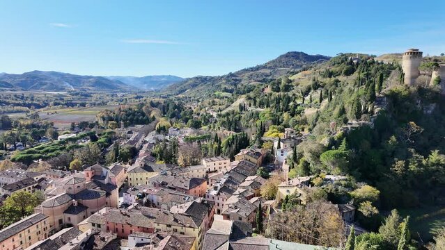 panoramic view from 19th-century Clock Tower of Brisighella village in Italy's Lamone Valley. Brisighella town skyline with Brisighella stronghold: the famous Rocca Manfrediana in Italy.