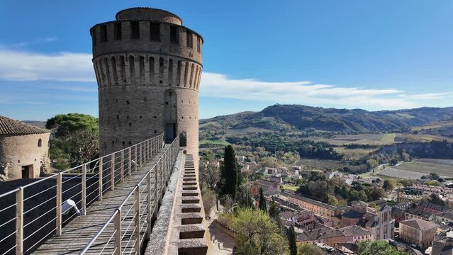 Aerial view on Brisighella village in Lamone Valley of the Tuscan-Romagnolo Apennines in Italy. From Brisighella Castle, known as the Rocca Manfrediana, with the Monticino sanctuary on the horizon.