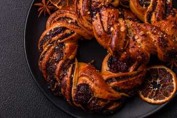 Delicious fresh baked bun with poppy seeds and berries