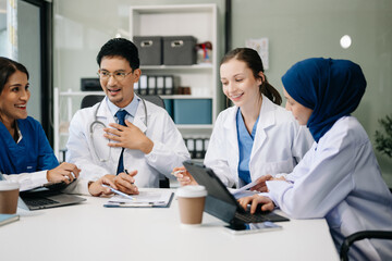 Medical, meeting and laptop for team in discussion, brainstorming and planning. Doctor, nurse on desk show diversity in collaboration, teamwork or workshop in hospital .