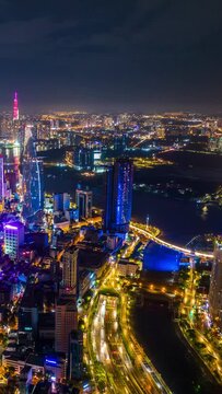 Vertical video, Hyperlapse Aerial view of beautiful night traffic and city lights in Ho Chi Minh City, Vietnam.	
