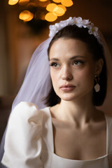 Fototapeta premium beautiful woman model bride in a wedding dress, portrait of a bride with a wreath on her head