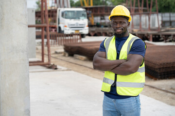 Cross arm Portrait African engineer man with precast cement at precast cement outdoor factory	