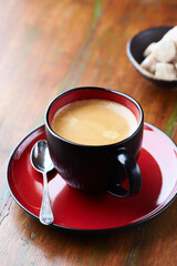 Cup of coffee on wooden background.