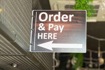 Hanging order and pay here sign board.