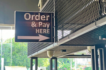 Hanging order and pay here sign board.