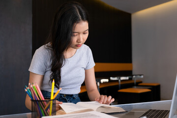 Young woman engages in business study at workspace.