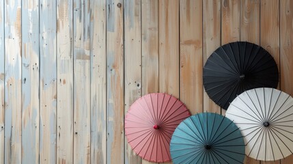 Three umbrellas next to light wood wall ready for decoration