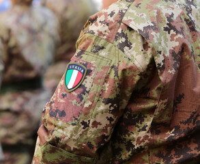Italian army soldier in green and brown camouflage uniform with Italian flag © ChiccoDodiFC