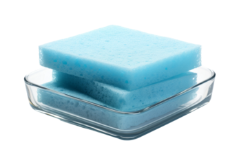 Stacked Blue Sponge Squares Resting in a Glass Dish on a Clear PNG or White Background.