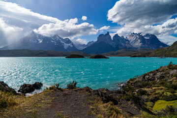Cerro Paine Grande, Cerro Paine Grande, and Mont Almirante Nieto during a rainy and sunny day behind Lago Pehoe
