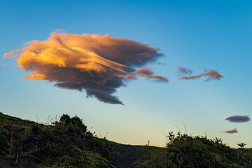 Windswept cloud during a golden sunrise in Patagonia