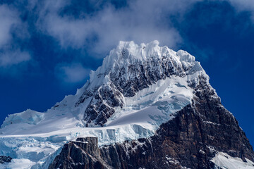 A majestic view of the snow, ice, and glacier capped peak of the Cerro Paine Grande