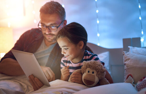 Bedtime, storytelling on tablet with dad and daughter in bedroom of home together for bonding. Family, fantasy and smile with single parent reading to girl child in bed for relationship or relax - Powered by Adobe