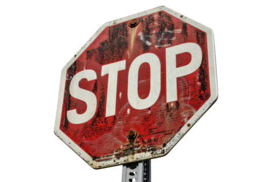 Weathered stop sign, close-up view. Sign shows wear and fading, adding character and history, set against a plain background.
