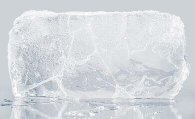 A textured block of transparent ice on a light gray background.