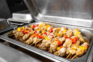 Grilled chicken skewers with red and yellow bell peppers, seasoned and ready to serve