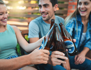 People, beer and drinks for backyard party with cheers and outdoor celebration or happy social hangout. Group of friends, talking and toast together with cool beverage or alcohol bottle at home patio