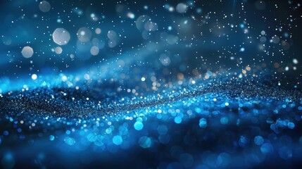 A blue abstract background with bokeh lights and glittering particles