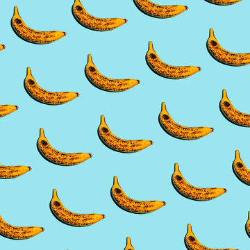 Repeating ripe banana pattern on a bright blue background
