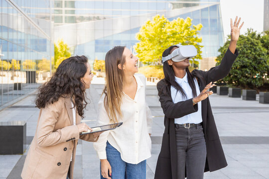 Women testing virtual reality technology at urban setting