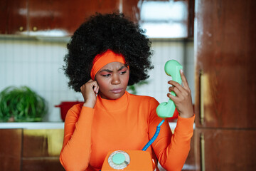 Confused woman in 50s attire holding retro telephone