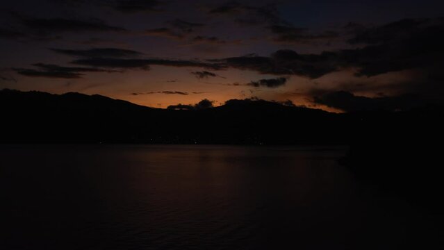 magnificent time lapse of lake atitlan in guatemala showing the beautiful colors of the sunrise and large body of water in the morning