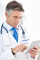 Doctor, man and research on tablet or telehealth, information or hospital. Digital technology, mature person or medical professional and reading email on internet as wellness report or clinic results