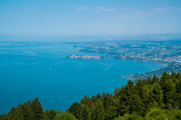 Germany, Panorama nature landscape view above green tree rops to lindau island at lake constance bodensee in summer with blue sky