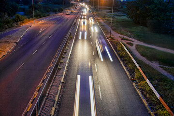 car trail lights in the night viewpoint from above a bridge