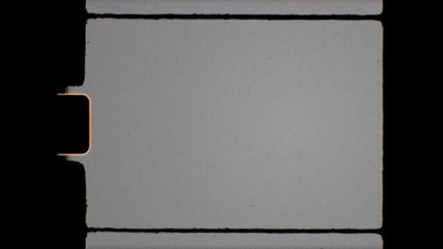 Vintage 8mm film frame with a blank, grey screen and black edges. Classic Super8 film reel effect for retro projects. Use 'Hard Light' blending mode