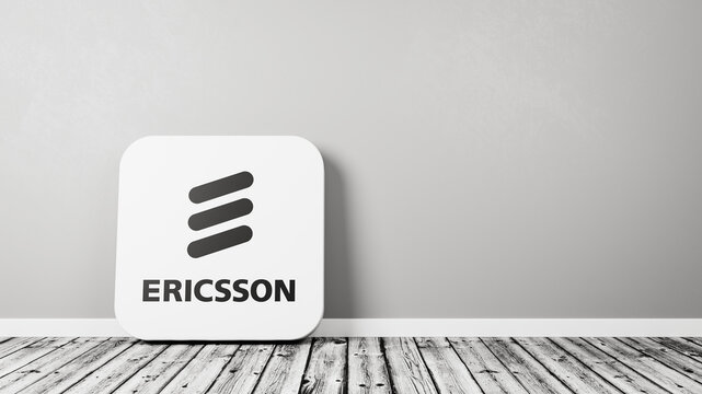 Ericsson App Icon on Wooden Floor Against Wall